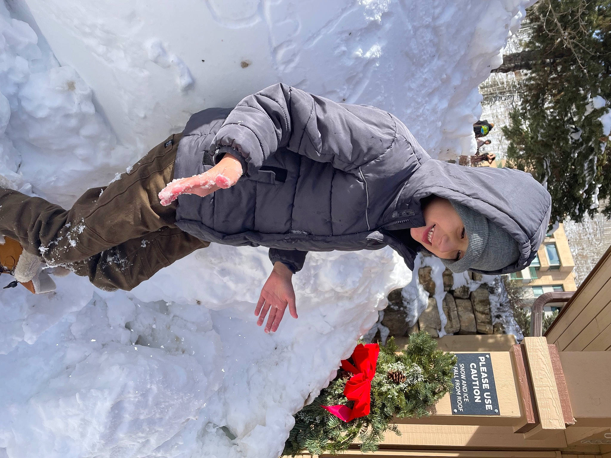Mason is registered to the contest to win money with this photo: adventure, event, freezing, fun, glacial_landform, glove, happy, hat, headwear, ice_cap, jacket, joy, leisure, person, plant, playing_in_the_snow, recreation, snow, tree, vacation