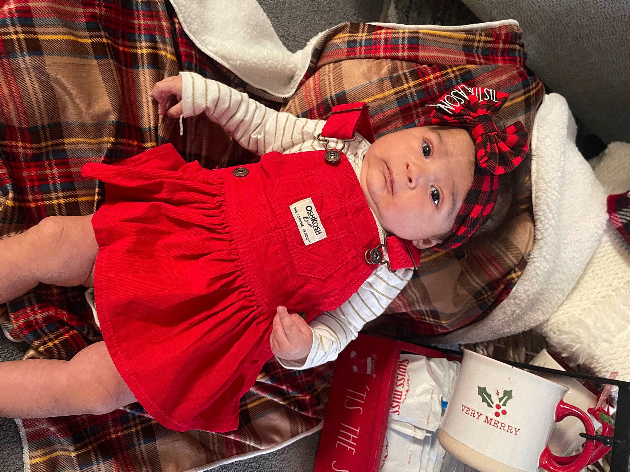 Sofia joined the competition — help win amazing prizes! baby, baby_toddler_clothing, carmine, child, christmas, christmas_eve, comfort, event, face, head, headwear, holiday, lap, pattern, person, plaid, red, sleeve, sock, tartan