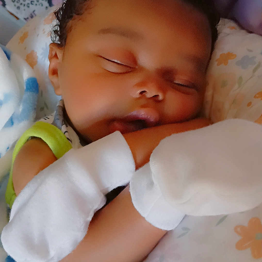 Braylen is registered to the contest to win money with this photo: baby, bed, blanket, child, closeup, comfort, cozy, curly_hair, cute, face, indoors, infant, mittens, peaceful, pillow, portrait, resting, sleeping, soft, toddler