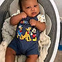 baby, infant, child, mickey_mouse, donald_duck, pluto, cartoon_characters, onesie, baby_seat, blanket, indoor, cute, portrait, expression, furniture, floor, clothing, person, resting, casual