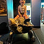 Asher joined the competition — help win amazing prizes! child, toddler, tortoise, statue, sculpture, museum, indoor, carpet, person, curious, tank_top, shorts, footwear, exhibit, lighting, shadow, background, visitor, blue_wall, window
