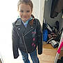 Phoenix joined the competition — help win amazing prizes! child, girl, smile, leather_jacket, jeans, sneakers, braid, indoor, open_closet, shoes, tablet, wooden_floor, casual_clothing, standing, portrait, daylight, happy, person, home, fashion