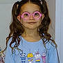 child, girl, glasses, pigtails, curly_hair, blue_sweatshirt, cartoon_print, indoor, smile, portrait, cute, fashion, eyewear, hair_ties, childhood, young, person, casual_clothing, happy, standing