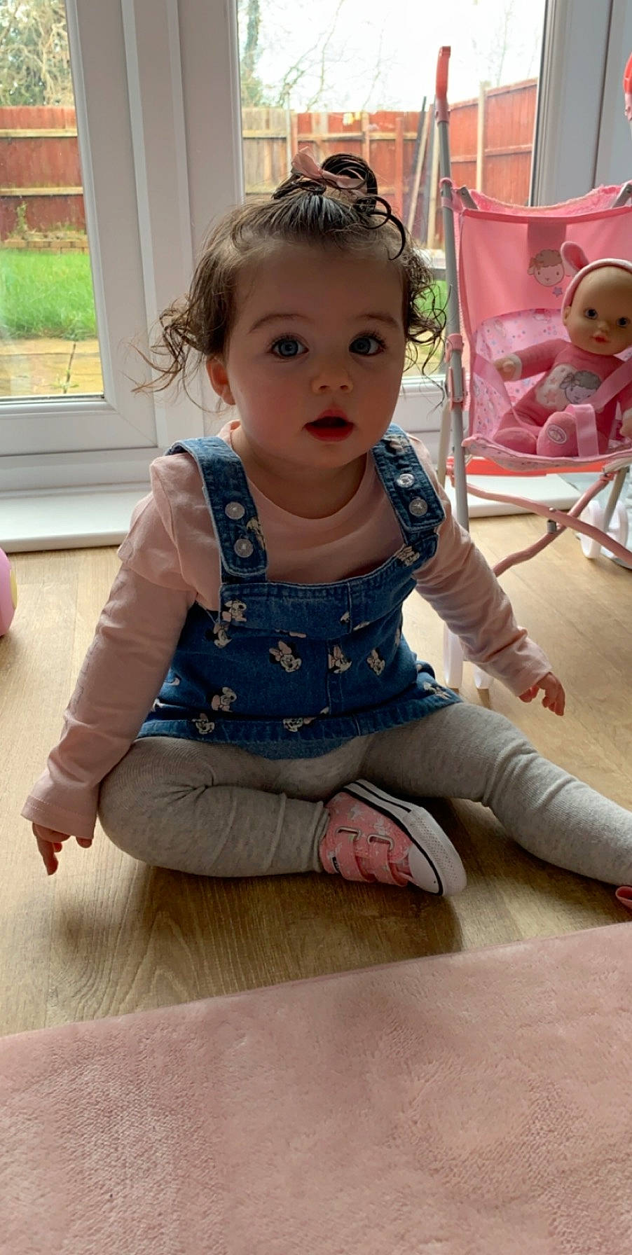 Lexie is registered to the contest to win money with this photo: baby, cheek, child, daughter, fawn, floor, flooring, leg, neck, outerwear, person, play, sitting, skin, sleeve, smile, surprise, toddler