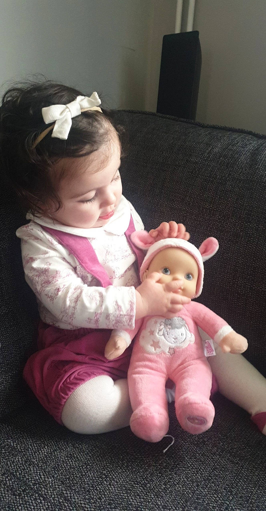 Lexie joined the competition — help win amazing prizes! baby, brown_hair, cheek, child, doll, ear, hair_accessory, hand, head, headgear, joint, person, pink, sibling, sitting, skin, toddler, toy