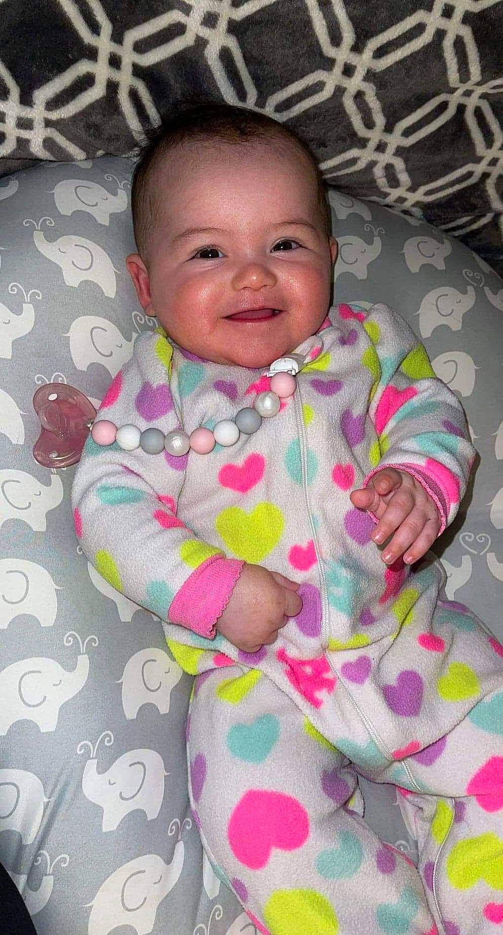 Trinity is registered to the contest to win money with this photo: baby, baby_toddler_clothing, cheek, comfort, eye, facial_expression, happy, head, iris, joy, lip, mouth, nose, person, pink, product, purple, skin, sleeve, smile