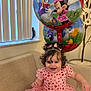 Elizabeth joined the competition — help win amazing prizes! child, toddler, pink_dress, heart_pattern, balloons, minnie_mouse, daisy_duck, couch, vertical_blinds, flowers, potted_plant, curly_hair, hair_bows, smile, sitting, celebration, party, indoor, portrait, happy