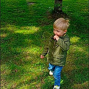 Lorenzo participe au concours pour gagner de l'argent avec cette photo : child, grass, tree, jacket, jeans, shoe, outdoor, nature, daylight, house, greenery, casual_clothing, young_boy, standing, sunlight, shadow, leafy, yard, curious, portrait