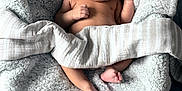 Michael is registered to the contest to win money with this photo: baby, bedroom, blanket, child, comfort, cozy, cute, indoor, infant, newborn, peaceful, person, plush_toy, resting, skin, sleeping, soft_texture, striped_cloth, toddler, toy