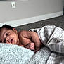 Michael joined the competition — help win amazing prizes! baby, blanket, candid, carpet, child, cozy, curious, decorative_blocks, face, floor, hand, indoor, infant, lying_down, newborn, portrait, resting, skin, soft_texture, striped_cloth