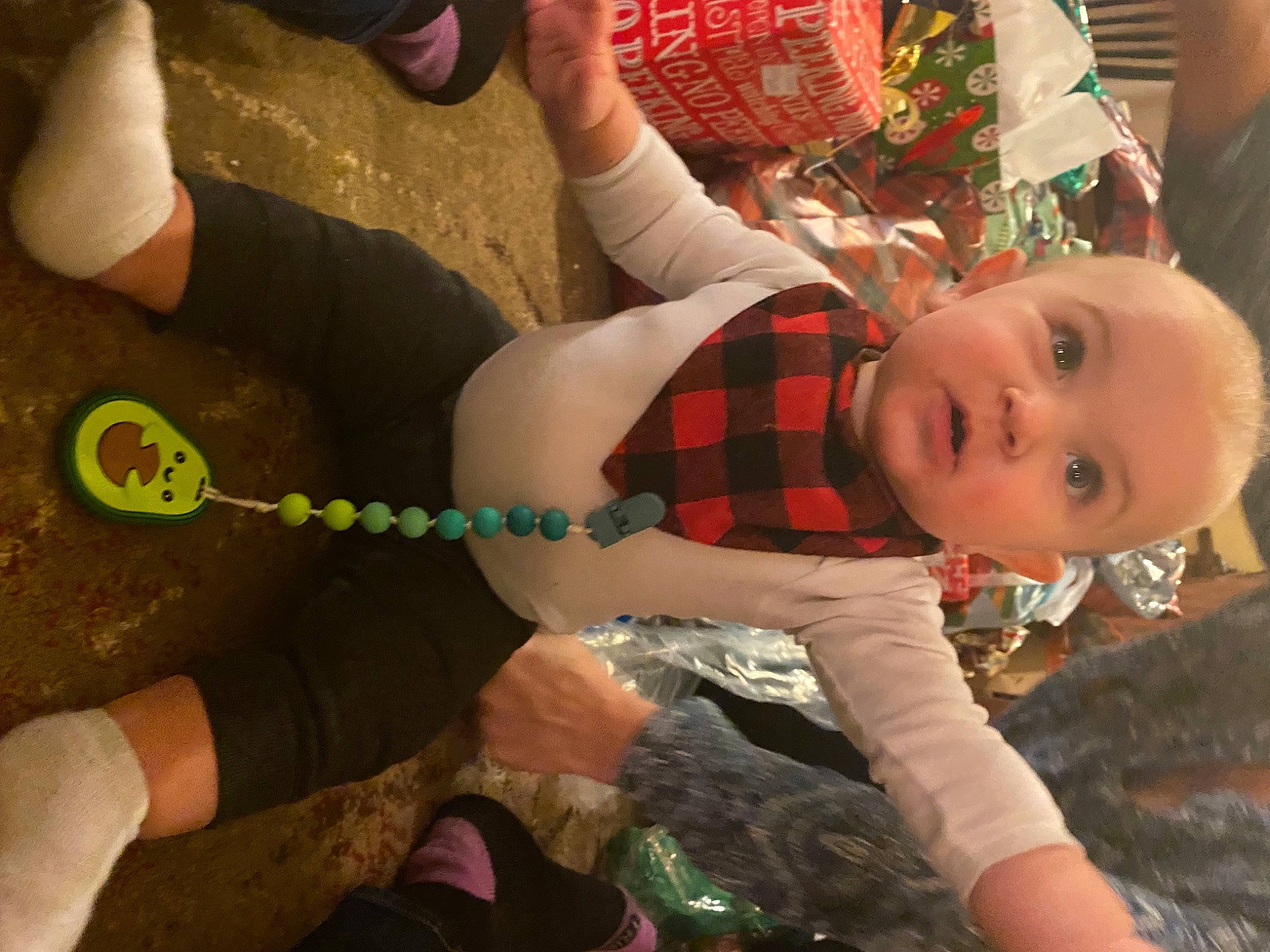 Dexter is registered to the contest to win money with this photo: baby, baby_toddler_clothing, comfort, fun, grass, hand, happy, human_leg, knee, lap, leg, person, plaid, sneakers, sock, sportswear, tartan, textile, thigh, toddler