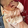 baby, infant, child, sleeping, face, hand, pink_clothing, onesie, polka_dots, portrait, indoor, cuddling, adult, arms, blanket, soft_lighting, resting, newborn, family, cute