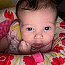 Roselee joined the competition — help win amazing prizes! baby, infant, child, face, portrait, wide_eyes, looking_at_camera, indoors, bedding, pillow, floral_pattern, pink_clothing, yellow_clothing, red_flowers, brown_hair, fair_skin, close_up, sitting, hand_under_chin, cozy