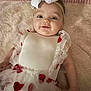 baby, infant, smiling, headband, bow, dress, heart_pattern, tulle, blanket, portrait, eyes, cheeks, lying_down, cute, adorable, arm, fabric, soft_texture, rug, towel