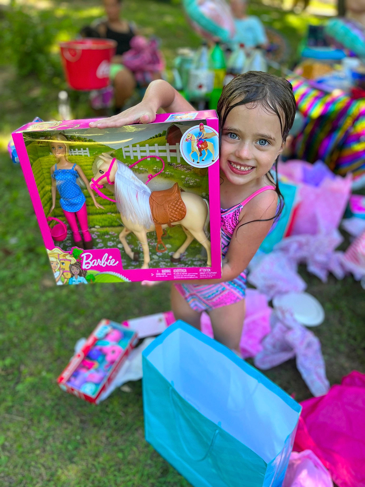 Harley is registered to the contest to win money with this photo: child, event, fawn, fun, grass, happy, holiday, joy, leisure, magenta, party, person, pink, public_event, public_space, recreation, sitting, smile, summer, sunglasses