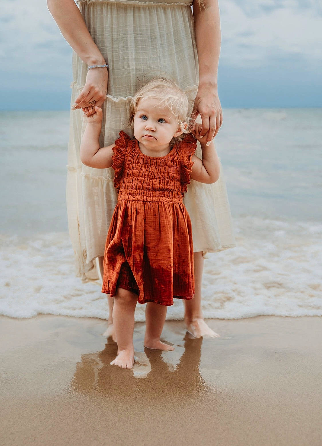 Gracie joined the competition — help win amazing prizes! barefoot, beach, blue, dress, face, gesture, happy, head, human_body, leg, outerwear, person, skin, sky, sleeve, summer, thigh, toddler, waist, water