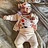 Giavanna is registered to the contest to win money with this photo: baby, blanket, cardigan, clothing, cute, fall_theme, footwear, ghost, happy, headband, indoors, infant, lying_down, pacifier, pants, pumpkin, smiling, soft_toys, spider, warm