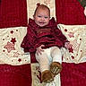 Giavanna is registered to the contest to win money with this photo: baby, baby_clothing, blanket, brown_booties, cheerful, child, cozy, cute, floor, happy, holiday_theme, indoor, infant, lying_down, person, portrait, red_dress, smiling, star_pattern, white_tights