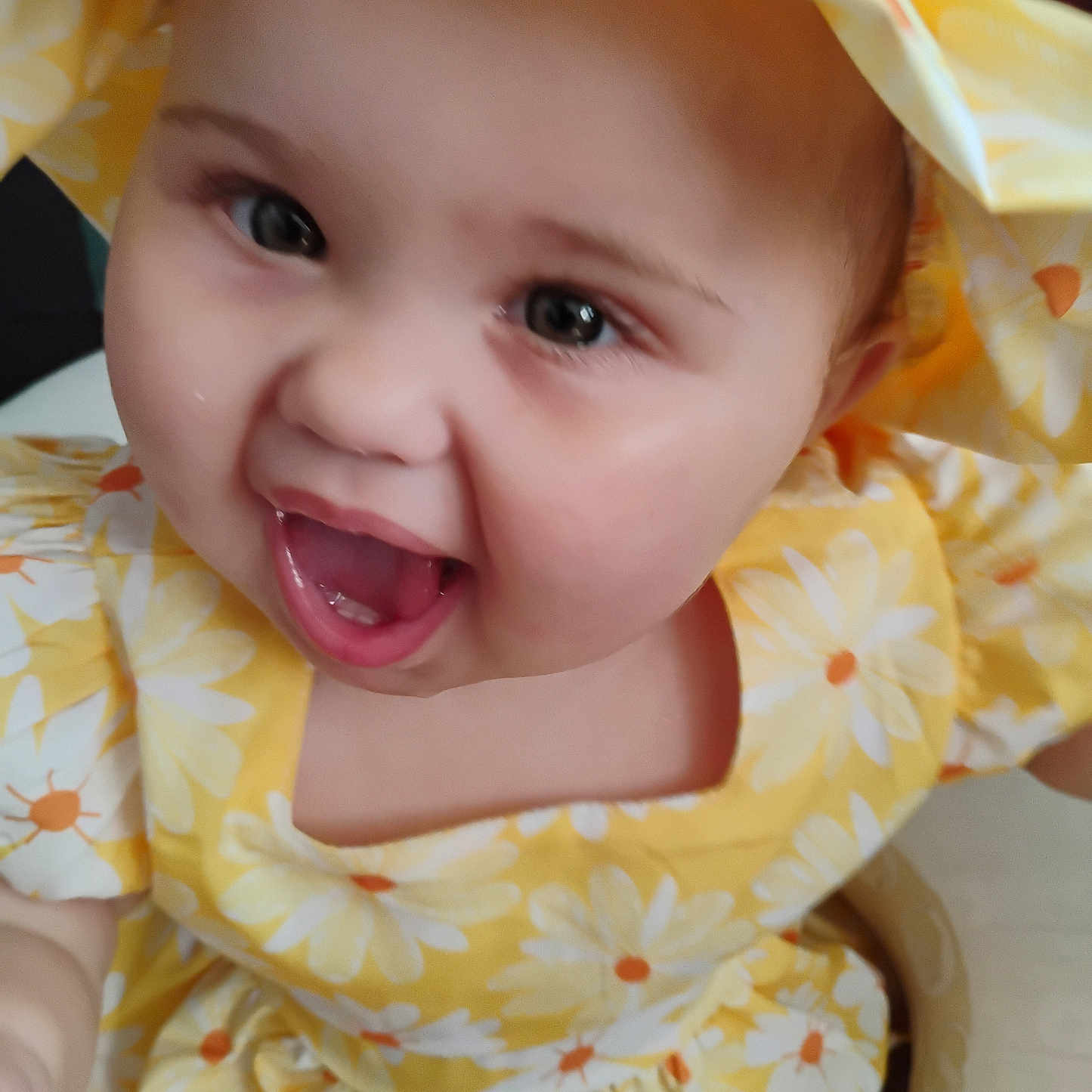 Olivia Jeanmarie joined the competition — help win amazing prizes! apparel, baby, cheerful, child, closeup, cute, expressive, face, flower_pattern, happy, headwear, indoors, infant, joyful, person, portrait, skin, smiling, yellow_dress, young_child