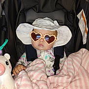 Olivia Jeanmarie joined the competition — help win amazing prizes! baby, car_seat, heart_shaped_sunglasses, white_hat, pink_blanket, plush_toy, child, infant, cute, wrapped, seatbelt, clothing, accessory, indoors, portrait, serious_face, toy, fabric, protection, babywear