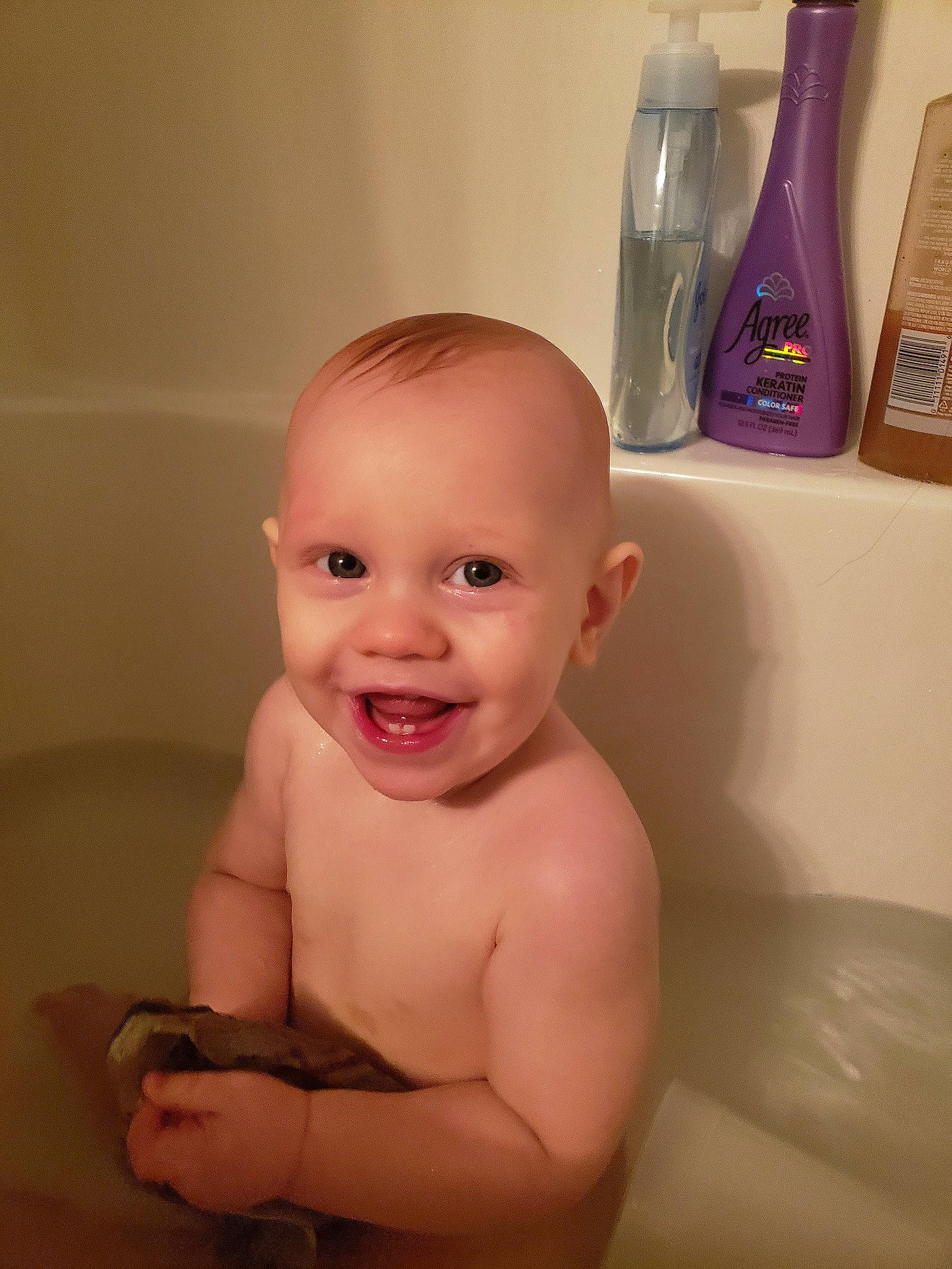 Leighton joined the competition — help win amazing prizes! baby, baby_bathing, bathing, bathtub, child, face, facial_expression, finger, forehead, head, joy, mouth, nose, person, skin, smile, stomach, thumb, toddler