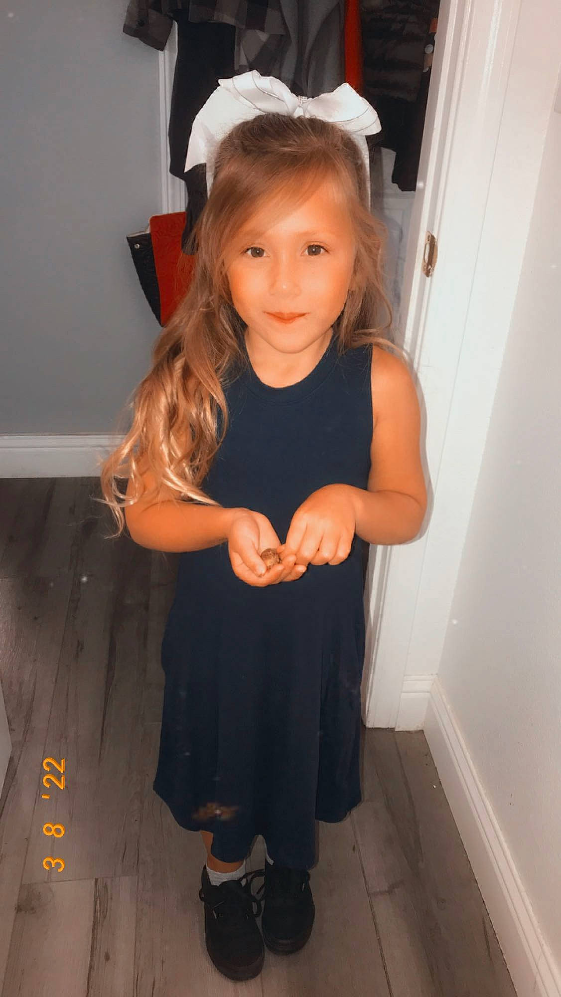 Averie is registered to the contest to win money with this photo: blond, brown_hair, child, door, flooring, fun, gesture, hair, happy, human_leg, iris, long_hair, person, room, shoulder, skin, sleeve, smile, standing, toddler
