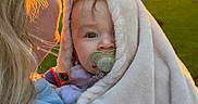 Noah participe au concours pour gagner de l'argent avec cette photo : baby, blanket, pacifier, person, blonde_hair, sunlight, outdoor, trees, green_grass, golden_hour, hug, soft_texture, smile, face, child, warm_light, nature, happy, cute, cozy
