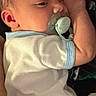 baby, newborn, pacifier, onesie, sleeping, infant, child, cute, lying_down, closeup, face, skin, hand, arm, soft_light, indoors, calm, resting, young, portrait