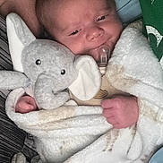 Oliver joined the competition — help win amazing prizes! baby, blanket, plush_toy, elephant_toy, pacifier, infant, bed, cozy, sleepwear, child, cute, soft, wrapped, resting, comfort, newborn, human, indoors, portrait, clothing