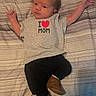 baby, infant, clothing, shirt, bed, blanket, striped, footwear, boots, person, child, lying_down, cute, expression, skin, hands, face, young, home, indoors