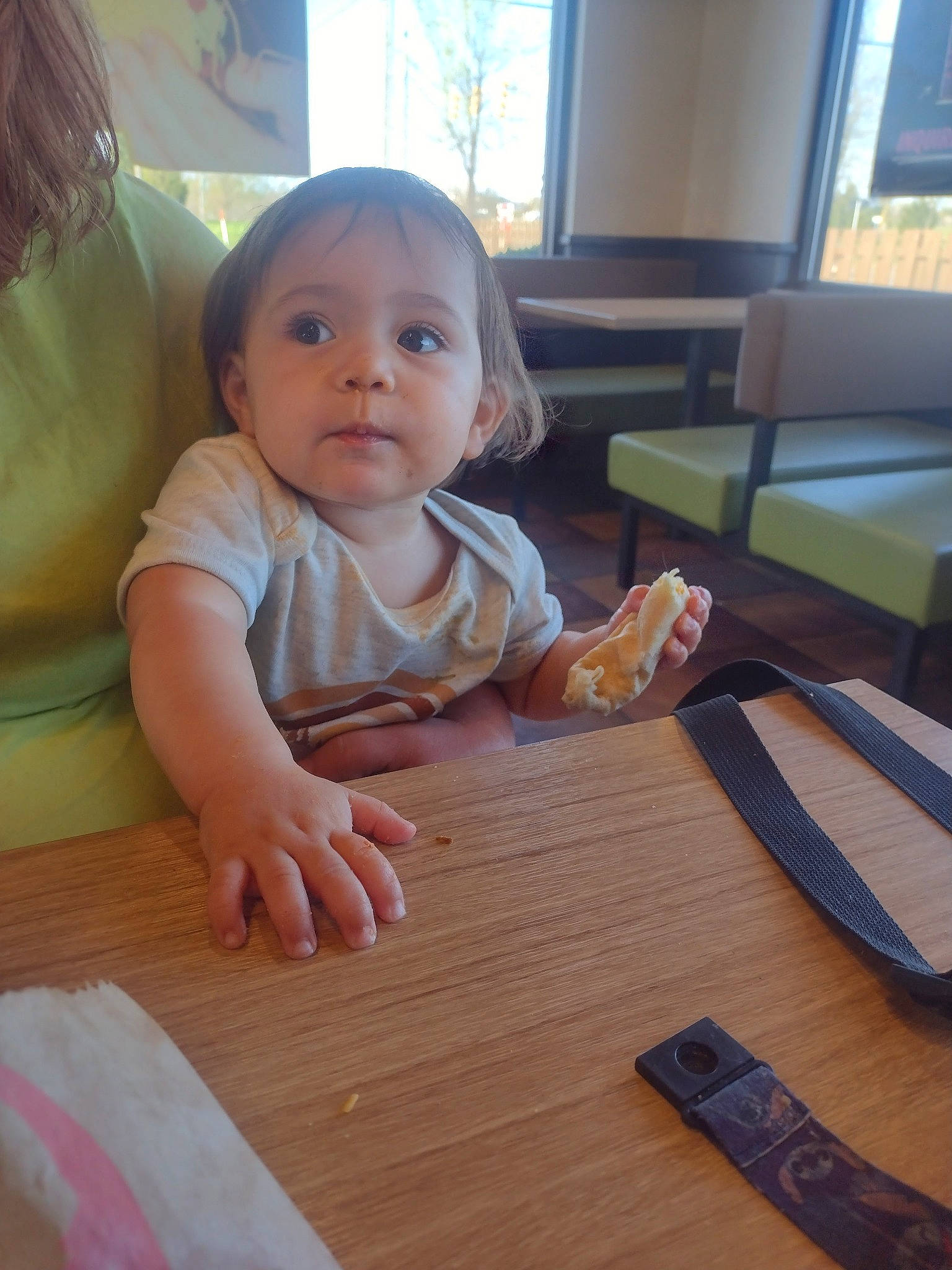 Daniella is registered to the contest to win money with this photo: baby, baby_toddler_clothing, cheek, child, comfort, finger, floor, flooring, hardwood, person, room, sitting, skin, table, thumb, toddler, varnish, window, wood, wood_flooring