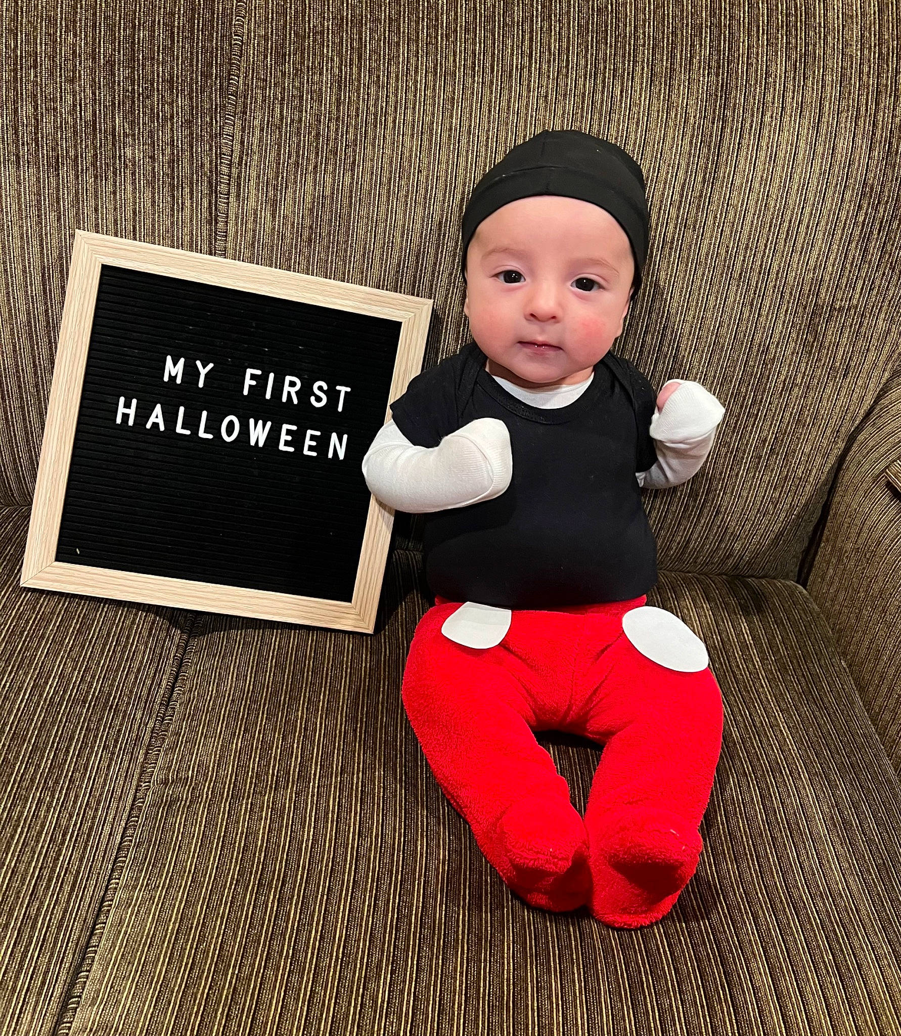Lucas is registered to the contest to win money with this photo: baby_toddler_clothing, carmine, child, clothing, eye, facial_expression, flooring, font, happy, head, headwear, human_body, human_leg, knee, person, product, rectangle, sitting, sleeve, t_shirt