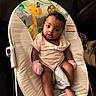 Samanii joined the competition — help win amazing prizes! baby, baby_seat, child, colorful, cute, expression, face, foot, giraffe_pattern, indoor, infant, legs, looking_at_camera, mittens, monkey_pattern, pink_clothing, portrait, seated, soft_lighting, young_baby