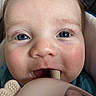Sterling is registered to the contest to win money with this photo: baby, close_up, face, blue_eyes, teething_toy, chewing, infant, cute, skin, hair, hand, mouth, child, portrait, soft, indoor, young, person, health, comfort