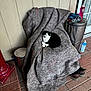 Scooter is registered to the contest to win money with this photo: black_and_white_cat, blanket, brick_floor, cat, chair, cleaning_supplies, cozy, domestic, door, fabric, feline, household, outdoor, pet, relaxing, resting, shoes, trash_can, wall, window