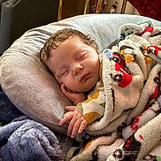 Briella is registered to the contest to win money with this photo: baby, sleeping, blanket, pillow, cozy, indoor, child, comfort, soft, couch, rest, peaceful, infant, home, wrapped, cute, relaxing, warm, toddler, person