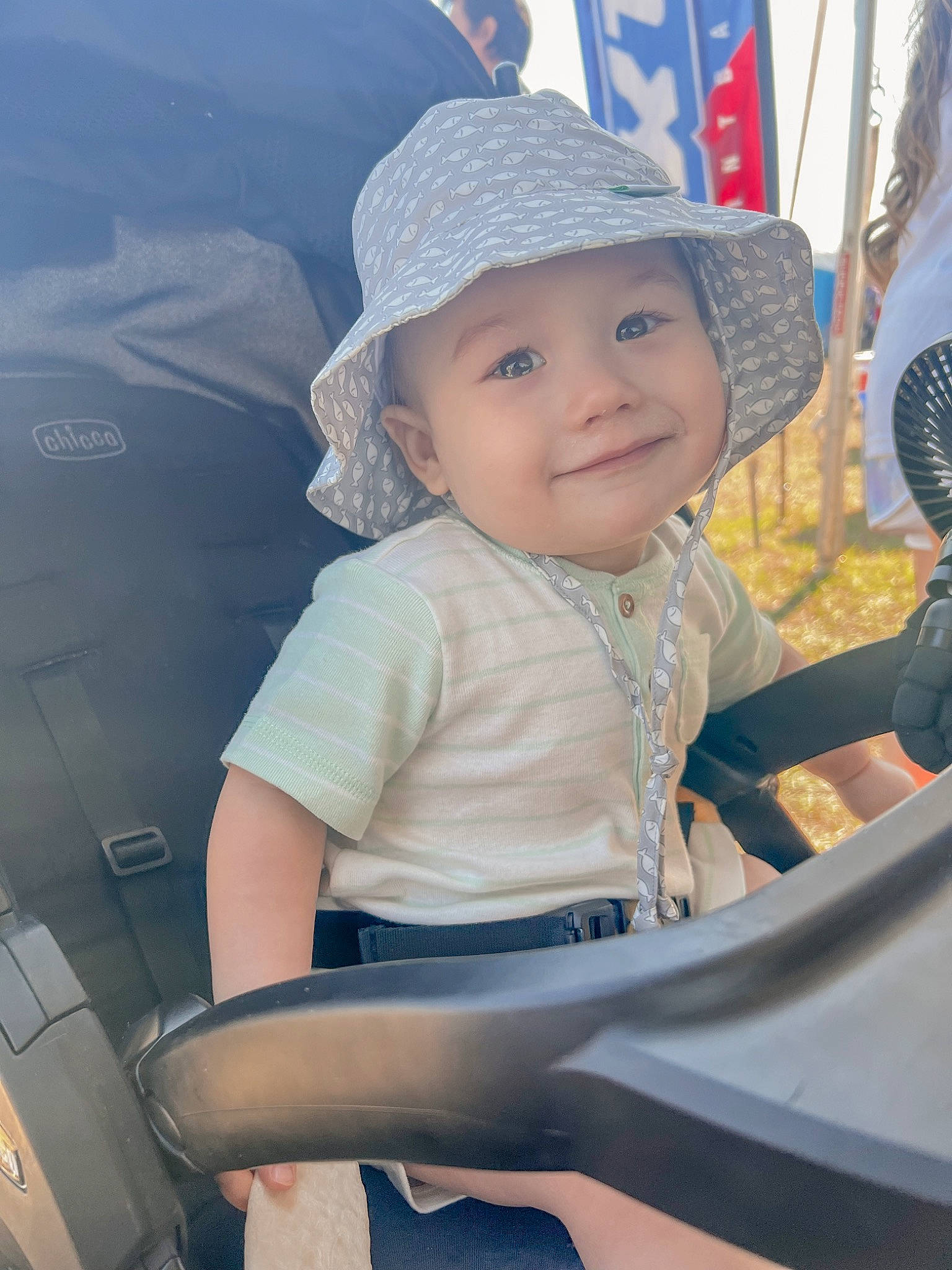 Bruce is registered to the contest to win money with this photo: auto_part, baby, baby_carriage, baby_products, baseball_cap, cap, child, electric_blue, fashion_accessory, fun, happy, hat, headgear, headwear, joy, leisure, person, recreation, skin, smile