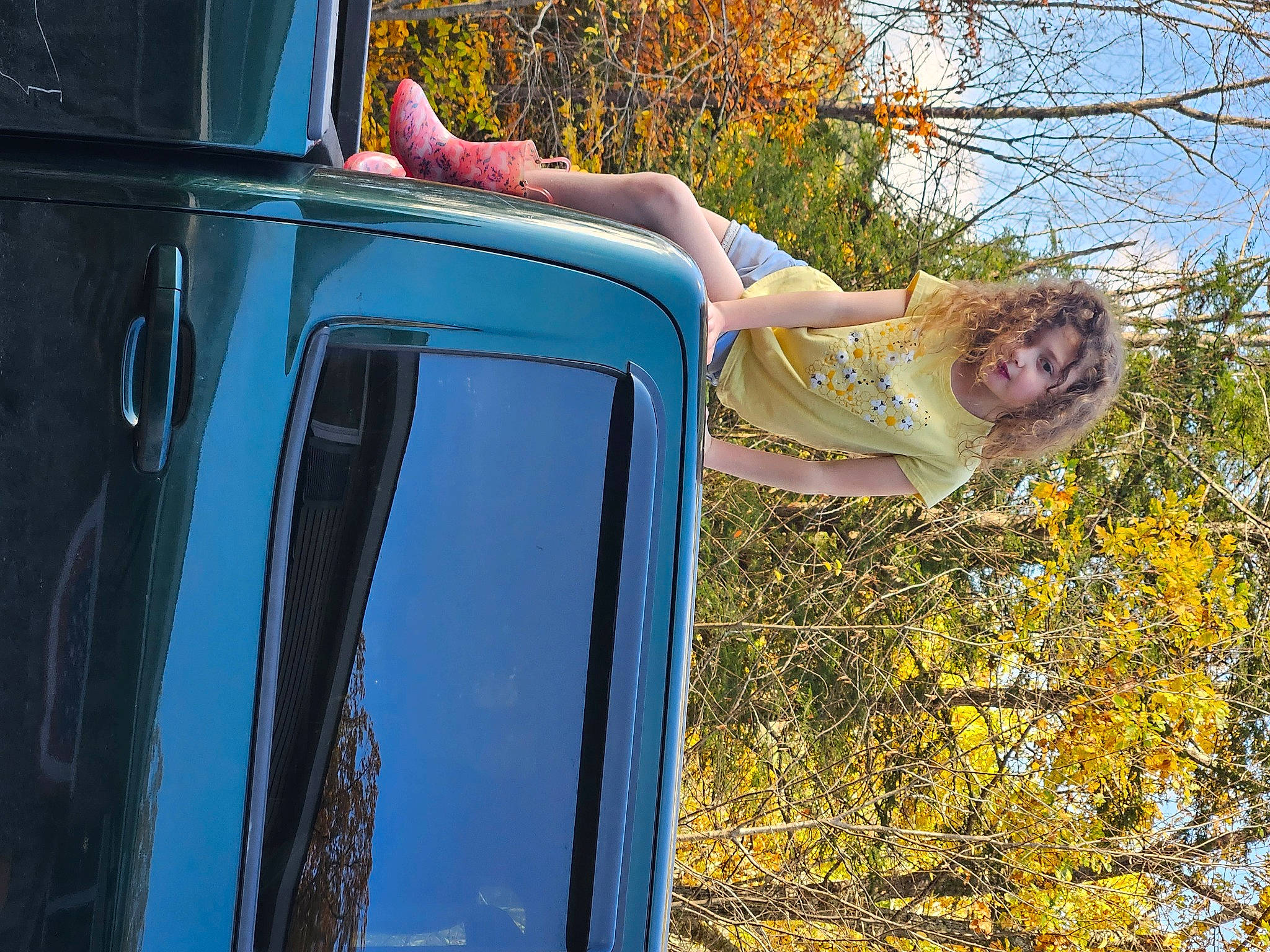 Angelina is registered to the contest to win money with this photo: auto_part, automotive_design, automotive_exterior, automotive_lighting, bumper, electric_blue, fun, grass, happy, leisure, motor_vehicle, people_in_nature, person, plant, recreation, tints_and_shades, travel, tree, twig, vehicle_door