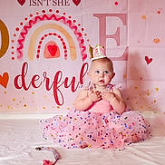 Lainey joined the competition — help win amazing prizes! baby, birthday, blue_eyes, celebration, child, crown, curious, cute, decorations, dress, festive, heart, indoor, infant, pink, portrait, rainbow, sitting, tutu_dress, white_blanket