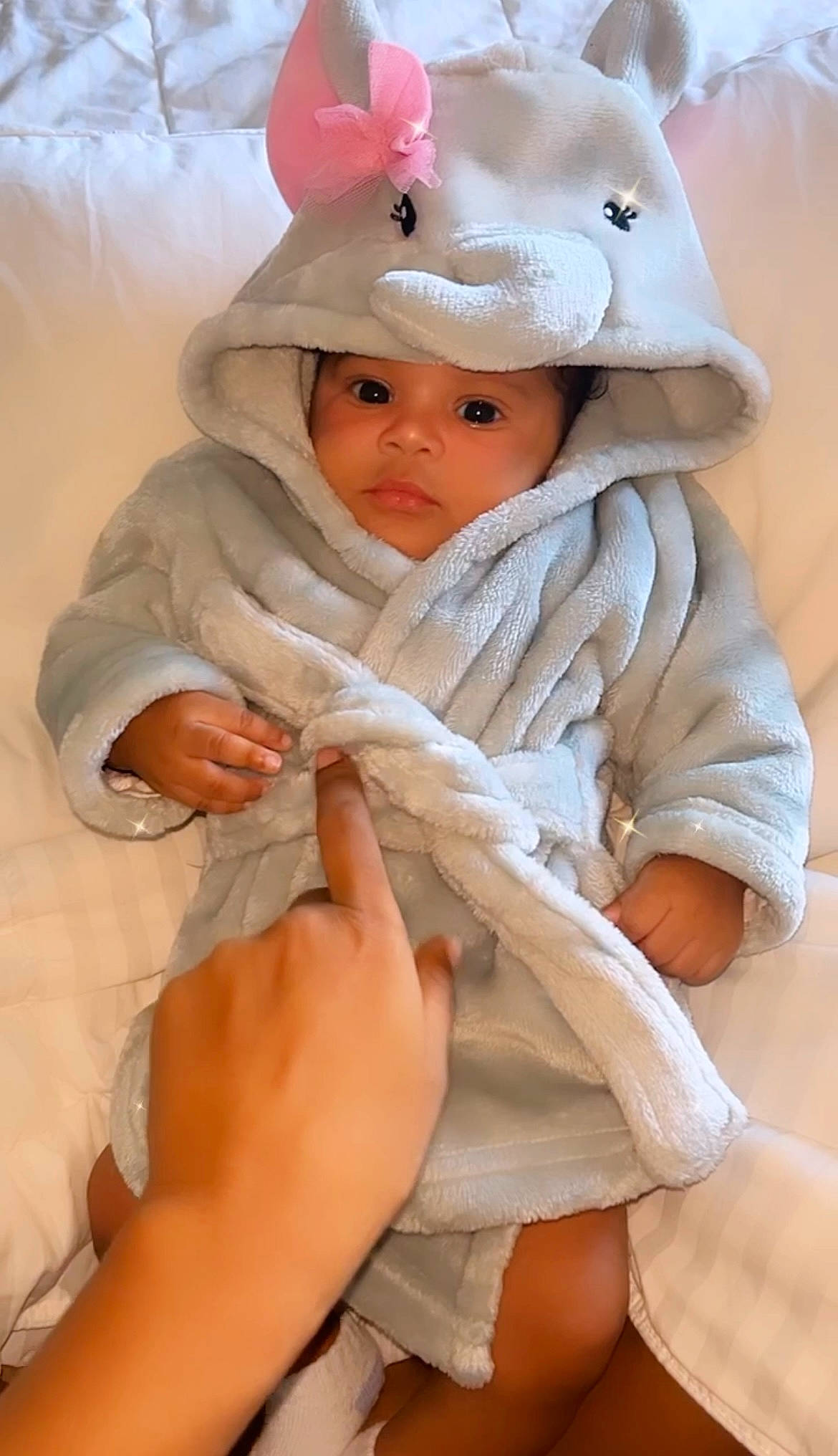 Demi is registered to the contest to win money with this photo: baby, baby_products, baby_toddler_clothing, cap, cheek, child, comfort, eye, fashion_accessory, finger, fur, gesture, happy, head, headwear, linens, peach, person, sleeve, thumb