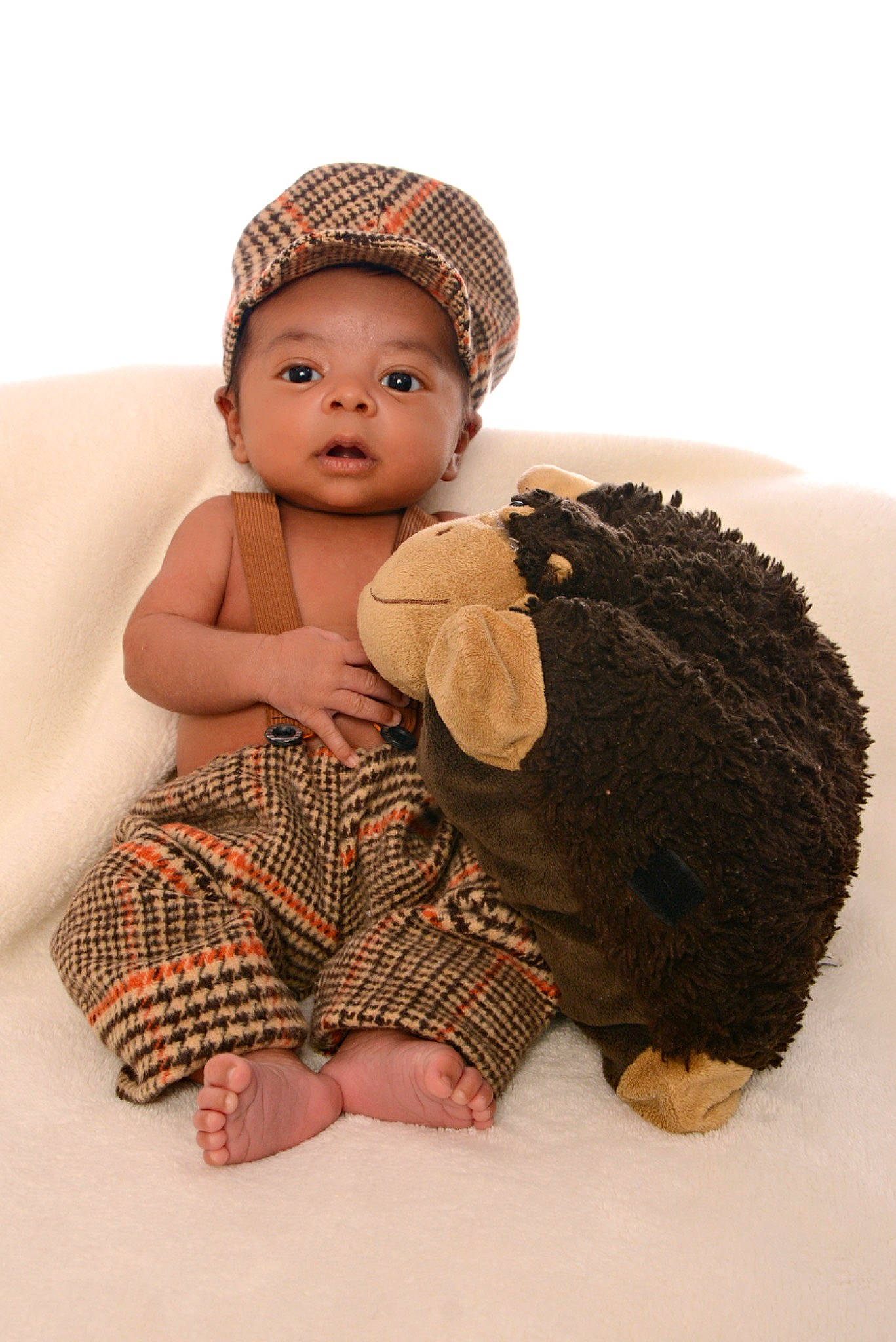 Princeton is registered to the contest to win money with this photo: baby, baby_toddler_clothing, cap, child, flash_photography, flooring, fur, headgear, headpiece, knit_cap, mammal, pattern, person, sitting, skin, sleeve, textile, toddler, toy, vertebrate