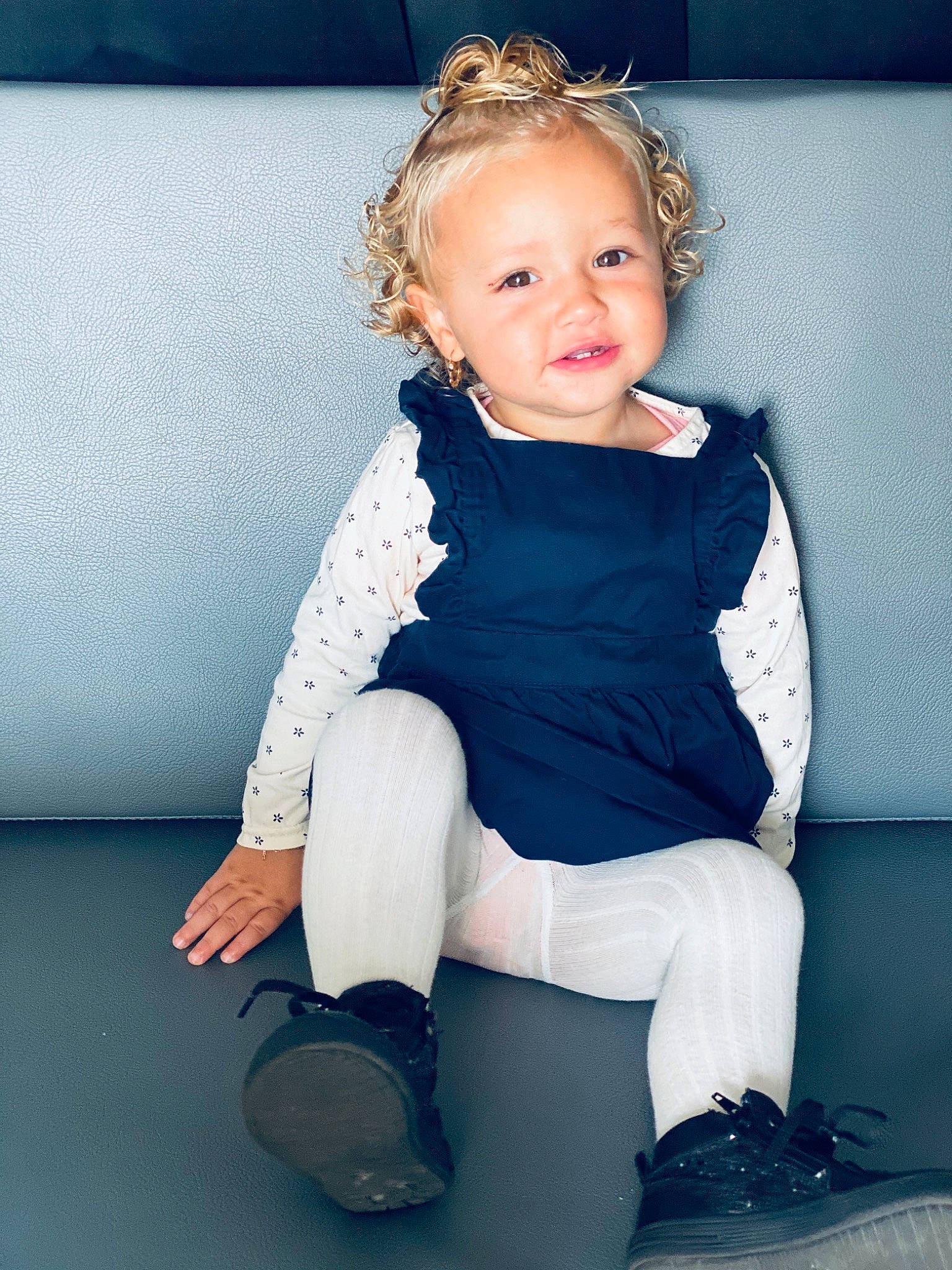 Linaya participe au concours pour gagner de l'argent avec cette photo : arm, baby, blond, blue, cheek, child, child_model, eye, face, hairstyle, iris, leg, person, sitting, skin, smile, standing, toddler