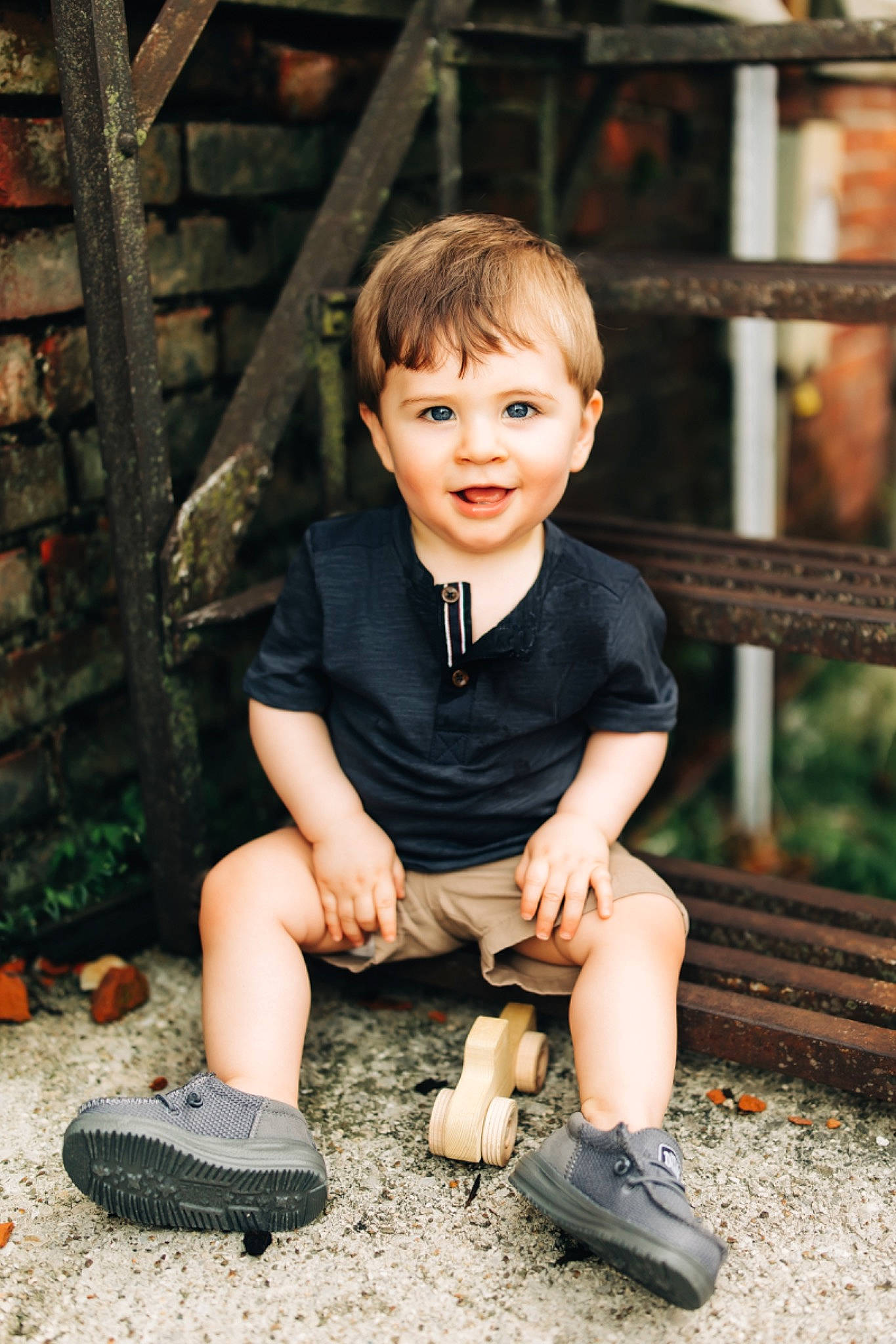 Briggs is registered to the contest to win money with this photo: blond, child, flash_photography, footwear, fun, grass, happy, joy, leaf, leisure, people_in_nature, person, plant, shoe, sitting, smile, sneakers, soil, standing, t_shirt