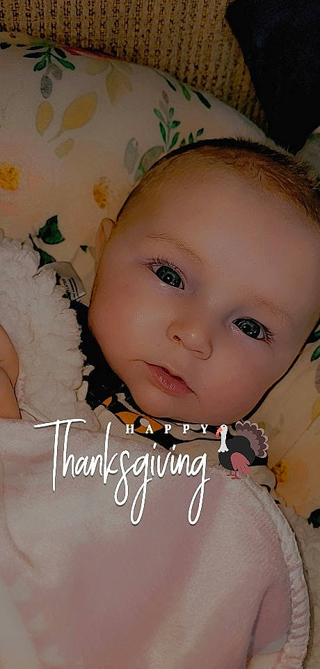 Allison is registered to the contest to win money with this photo: baby, baby_toddler_clothing, cheek, child, chin, eye, eyebrow, eyelash, face, fashion_accessory, flash_photography, grass, happy, head, iris, lip, pattern, person, portrait_photography, skin