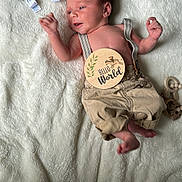 Dawson is registered to the contest to win money with this photo: baby, bed, blanket, bodypart, cutlery, face, finger, furniture, hand, head, homedecor, linen, newborn, person, photography, portrait, quilt, spoon, teddybear, toy
