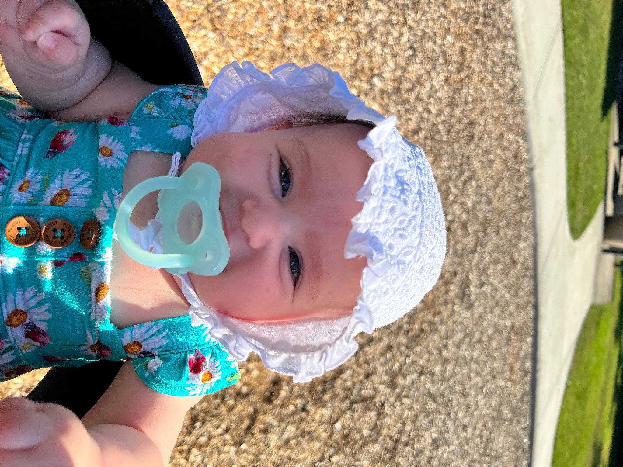 Rosie is registered to the contest to win money with this photo: baby, baby_toddler_clothing, cap, child, fashion_accessory, fun, grass, happy, hat, head, headwear, iris, leisure, lip, pattern, person, recreation, skin, smile, sun_hat