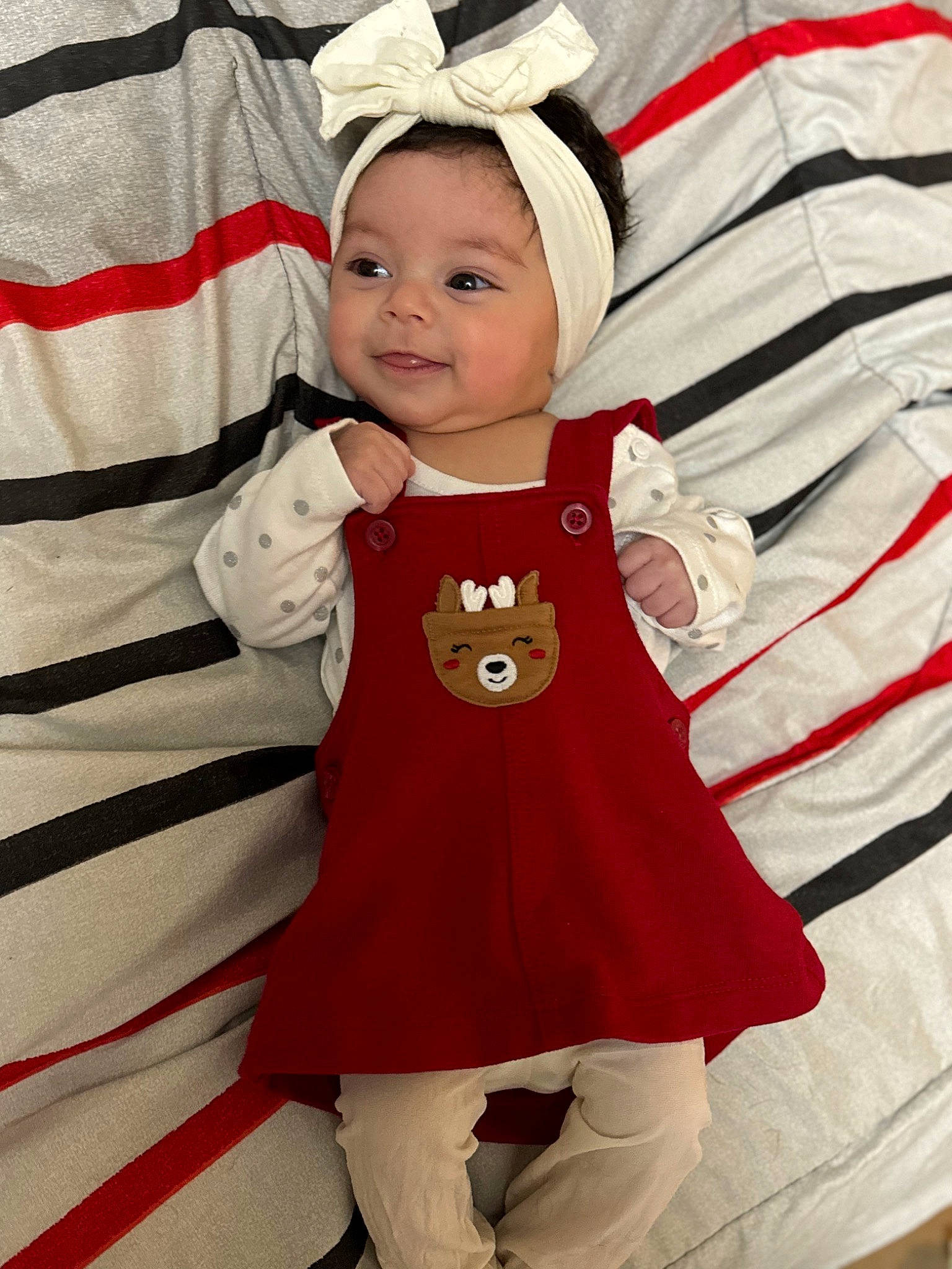 Khloee is registered to the contest to win money with this photo: baby, baby_toddler_clothing, cap, child, christmas, costume_hat, event, fictional_character, happy, headwear, joy, linens, magenta, outerwear, pattern, person, pink, sleeve, smile, t_shirt