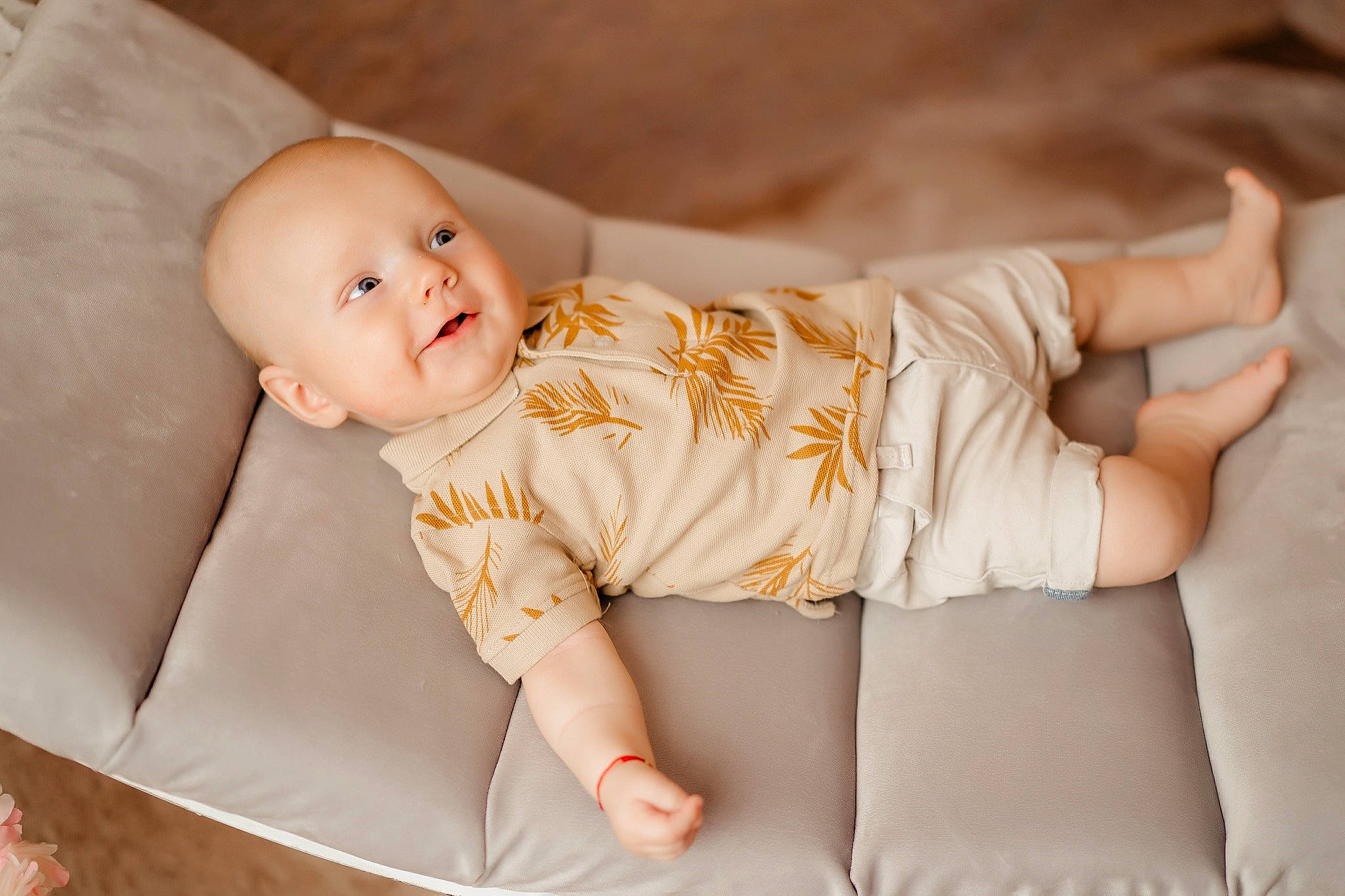 Aryan is registered to the contest to win money with this photo: baby, baby_toddler_clothing, child, comfort, couch, elbow, facial_expression, finger, foot, hand, happy, human_body, human_leg, knee, person, sitting, skin, sleeve, smile, thigh