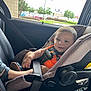 Ayedon joined the competition — help win amazing prizes! toddler, child, car_seat, orange_clothing, smiling, seatbelt, vehicle_interior, window, parked_cars, daylight, happy, face, hair, footwear, safety, seat, restraint, baby, car, child_safety