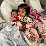 Alayia is registered to the contest to win money with this photo: baby, toddler, child, pajamas, bed, blanket, pillow, sleeping, smiling, indoor, cute, cozy, holiday, christmas, pattern, clothing, person, portrait, resting, family